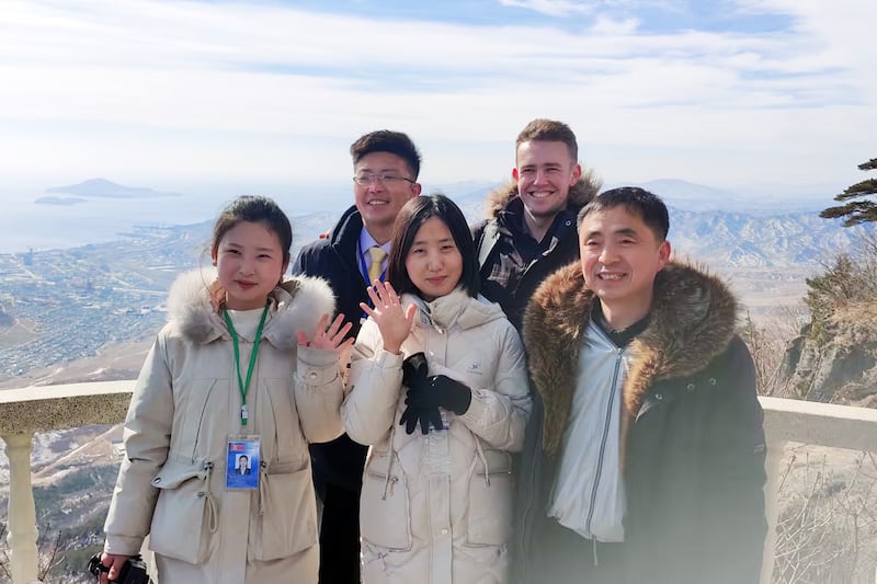 Tourists and guides pose for a picture in Rason, North Korea, Feb. 20, 2025.