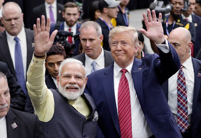 India Prime Minister Narendra Modi and then-President Donald Trump greet attendants after Modi's speech during the "Howdi Modi" event, Sept. 22, 2019, at NRG Stadium in Houston.