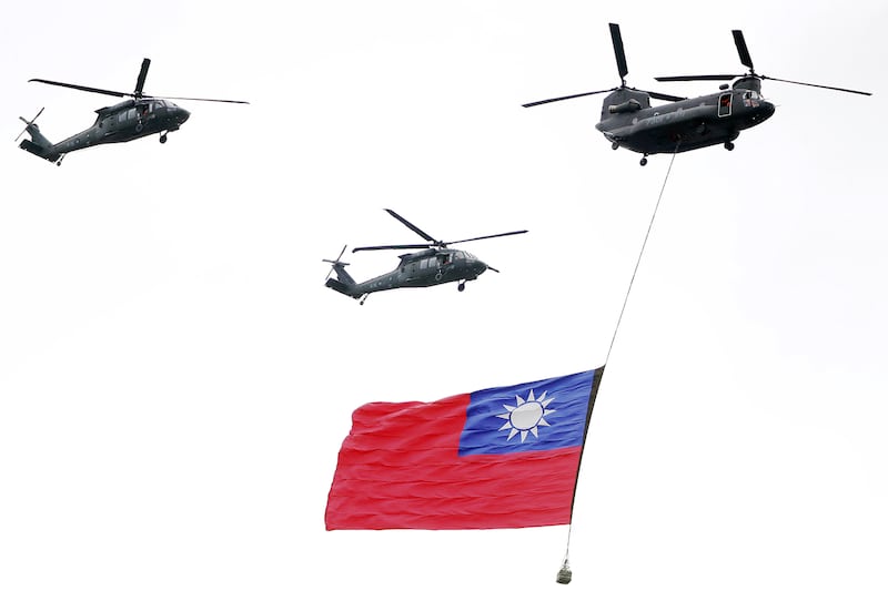 Military helicopters fly over with the Taiwan national flag during the inauguration celebration for Taiwan's President Lai Ching-te in Taipei, May 20, 2024.