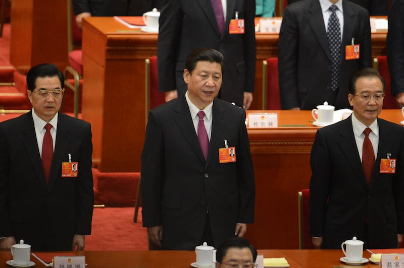 (L-R) Former Chinese president Hu Jintao, newly-elected Chinese President Xi Jinping and former premier Wen Jiabao sing the national anthem at the closing session of the National People's Congress (NPC) at the Great Hall of the People in Beijing on March 17, 2013.  Xi said he would fight for a "great renaissance of the Chinese nation", in his first speech as head of state of the world's most populous country.